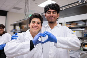 SEED Summer Rising students put up a heart in their lab coats